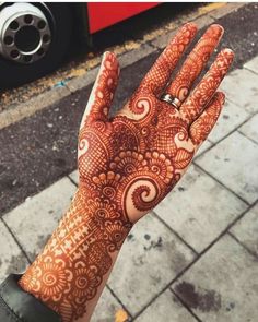 a hand with henna on it and the words beautiful henna written in arabic