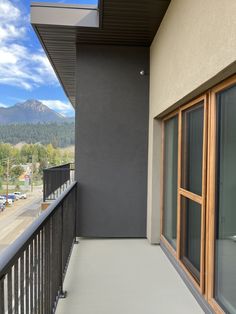 an empty balcony with mountains in the background