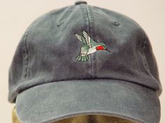 NEW EMBROIDERED HUMMINGBIRD WILDLIFE BIRD BASEBALL HAT  (HATS PICTURED ARE NAVY BLUE, KHAKI, CHARCOAL, OLIVE GREEN, FOREST GREEN, BLACK, WILD PLUM AND PALE PINK) Adams Optimum 6 Panel Baseball Hat Low Profile - 100% Cotton Twill Adult Cap Pigment Dyed - Garment Washed Hat 6 Panels with Sewn Matching Eyelet Visor with 3 Rows of Stitching Pre-formed Bill - Leather Strap with Brass Grommet Adjustable - One Size Fits Most An Extremely Comfortable Baseball Hat! Enjoy the Embroidered Hummingbird Wildlife Hat! We have 24 Different Solid Color Baseball Hats Available Please Choose the Color You Prefer! Thanks for Shopping at Price Embroidery & Apparel! Embroidered Hats Ideas, Embroidery Apparel, How To Wash Hats, Star Embroidery, Embroidery On Clothes, Embroidered Hats, Dad Caps, Cotton Twill Fabric, Mom Dad