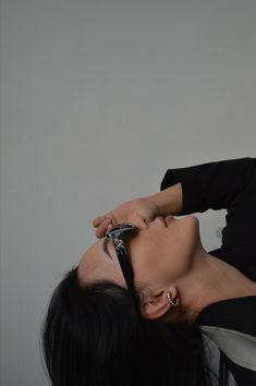 a woman is cutting her hair with scissors