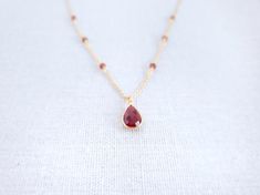 Garnet Pendant - Gold Garnet Necklace - Teardrop Necklace - Birthstone Necklace - Red Drop Necklace - January BirthstoneThe tiny red stone necklace is made of Garnet stone. Garnet is a stone of prosperity and abundance, encouraging gratitude and service to others.Garnet is the birthstone for the month of January and makes a lovely birthday gift.-------------MATERIALThe Garnet stone is in a teardrop 8x12mm setting and is made via hydrothermal process.---------------------------------------------- Red Briolette Necklaces For Jewelry Making, Red Briolette Beads For Jewelry Making, Red Teardrop Gemstone Drop Necklace, Red Teardrop Gemstone Necklace, Red Gemstone Drop Necklace For Gift, Ruby Drop Necklace For Gift, Red Drop Necklace For Gift, Real Ruby Necklace, Red Stone Necklace