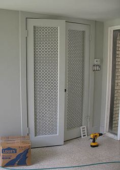 an empty room with two doors and boxes on the floor