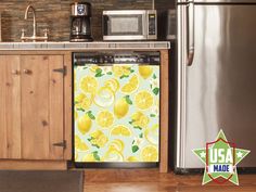 a kitchen scene with focus on the refrigerator and dishwasher that has lemons on it