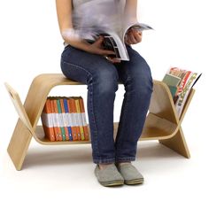 a woman is sitting on a chair with books