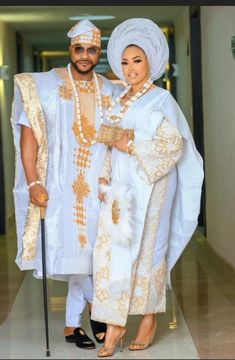 a man and woman dressed in traditional african garb