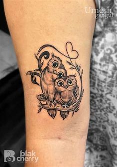 an owl and her baby tattoo on the arm