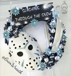 a white mask with blue snowflakes on it and a sign that says slashing through the snow