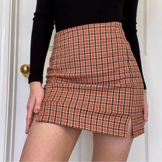 John Galt | Brandy Melville Orange, Black, Green And White Plaid Fitted Pencil Skirt. Two Small Slits On The Sides Of The Skirt. Stretchy Material And Zipper In The Back Of Skirt. Good Quality. Size: One Size Fits All (S/M) Fits 24-26. Style: Autumn, Fall, Winter, Seasonal, Skirts, Halloween, Christmas, Holiday Party, College Game Day, Back To School, Preppy, Cute, Princess Polly, Revolve, 90s Pencil Skirt, Forever 21, Prettylittlething. Condition: Excellent Condition, No Snags, Tears Or Stains, Orange Plaid Skirt, Back To School Preppy, School Preppy, Party College, Short Skirts Outfits, College Game Day, Plaid Skirt Outfit, Retro Outfit, Brandy Melville Skirts