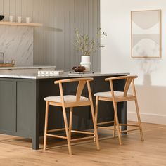 two wooden chairs sitting on top of a kitchen counter