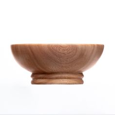 a wooden bowl sitting on top of a table