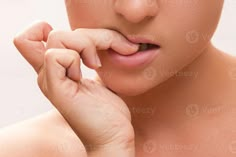 a woman is holding her finger to her lips