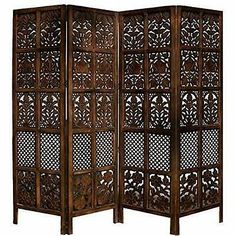 an ornate wooden room divider with intricate carvings