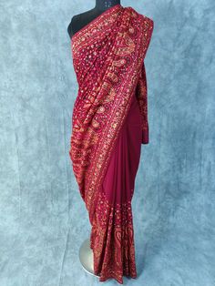 Kashmiri Embroidered Saree on Georgette with thread embroidery and some stones Fabric:  Georgette Length: 5.5 Meters | 6.1 yards Colour: Wine Blouse: Saree comes with blouse fabric. Base Color is same as Saree with border for sleeves or however you desire Please see product video for product details. If you have any questions message us anytime. Fall and Edging will be done complimentary.  Blouse Stitching (If Requested): Blouse will be stitched according to your measurements, which we will ask Thread Work Saree Embroidery, Bollywood Style Embroidered Pre-draped Saree For Diwali, Navratri Pre-draped Saree With Resham Embroidery, Traditional Embroidered Chanderi Pre-draped Saree, Traditional Pre-draped Saree With Dori Work For Eid, Bollywood Style Designer Embroidered Pre-draped Saree, Designer Bollywood Pre-draped Embroidered Saree, Diwali Embroidered Pre-draped Saree For Reception, Embroidered Pre-draped Saree For Diwali Reception