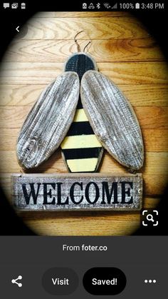 a wooden sign that says welcome with a bee on it's back and the words,