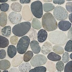 several different colored rocks are arranged on the wall in this mosaic tile pattern, which looks like it could be used as a floor covering