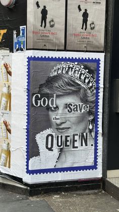 there is a poster on the side of a building that says god save the queen