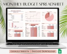 a laptop computer sitting on top of a desk with the words, month budget spreadsheet