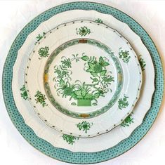 a green and white plate with flowers on it