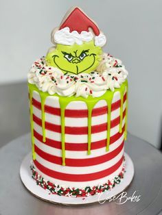 the grin face cake is decorated with white frosting and green icing on top