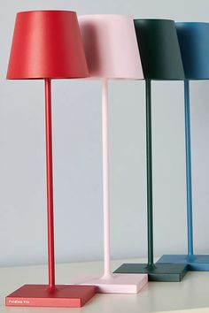 three different colored lamps sitting next to each other