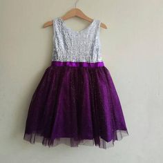 A sparkling silver sequined flower girl dress with glittered dark purple tulle skirt. The back is closing with invisible zipper and can be tighten around the waist with matching purple ribbon. Flower girls dress in purple wedding theme, I also can do another color, just leave me a note at the 'message to seller' box when check out or do not hesitate to contact me to inquiry.Custom Order Size: Please provide your child measurement: Chest and specific length otherwise you can also choose from my s Purple Tulle Dresses With Sequins, Purple Princess Dress With Sequins, Princess Style Purple Sequin Dress, Purple Sequined Princess Dress, Purple Glitter Tulle Party Dress, Purple Tulle Pageant Dress For Party, Pageant Dress With Sequins And Glitter Tulle, Purple Sequin Dress For Wedding, Bridesmaid Dress With Sequins And Glitter Tulle