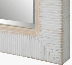 a white wooden frame with a mirror on it