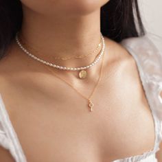 "A dainty pearl choker necklace with a single letter initial on a 14k gold filled round charm (can be customized to show 2 letters, rose, north star, or dandelion flower image instead by leaving a note at checkout). Round charm measures 10mm in diameter. Pearls are 2-3mm wide. Model is wearing the 14 inches. Made of 14K gold filled materials and genuine freshwater pearls, this choker necklace is tarnish-resistant, water-resistant, and hypoallergenic. --------------------♥ PROMOS ♥--------------- Dainty Pearl Chain Charm Necklace Choker, Dainty Pearl Chain Charm Necklace, Dainty Pearl Chain Choker Necklace, Dainty Charm Necklaces With Pearl Initial Pendant, Gold Dainty Pearl Necklace With Initial Pendant, Dainty Gold Pearl Necklace With Initial Pendant, Dainty Pearl Charm Necklace With Initial Pendant, Gold Key Necklace, Choker Pearl