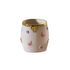 a white vase with gold trim and colorful butterflies on the outside, sitting against a white background