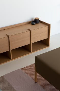 a wooden shelf sitting on top of a carpeted floor