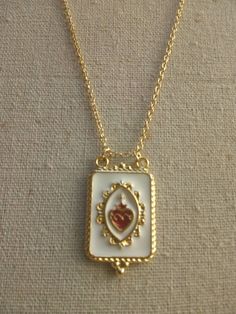 "You willl receive a beautiful Sacred Heart Pendant Necklace The scapuluar has enamel and is gold plated, the chain as well. Scapular meaures aprox 34mm x 22mm Necklace Length; 16\" inches 17\" 18\" 19\" 20\" 21\" 22\"" Gold Enamel Heart Necklace For Gift, Gold Enamel Heart Necklace For Valentine's Day, Valentine's Day Gold Enamel Heart Necklace, Scapular Necklace, Envelope Necklace, Heart Envelope, Catholic Necklace, Sacred Heart Of Jesus, Catholic Jewelry