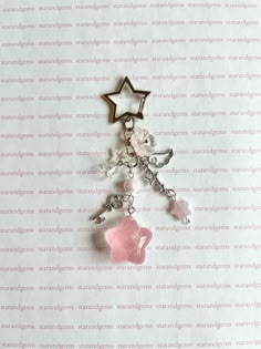 a key chain with two stars on it and charms attached to the back of it