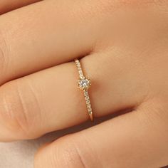 a woman's hand with a diamond ring on it