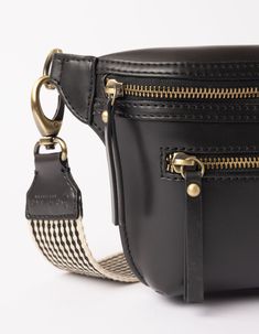 Our Beck’s Bum Bag in Vegan Uppeal™ has the same edgy but timeless design as our classic Beck, and comes with our iconic checkered webbing strap. Slightly lighter than our eco-leather design, this bag is completely vegan, so you can go hands free and guilt free! Whether you call it a fanny pack or a bum bag, we all know that this look will always be in. Style her crossbody for that classic bum bag look. OMB-A129CV Classic Black Belt Bag With Detachable Strap, Classic Black Bag With Removable Belt, Classic Black Belt Bag With Removable Pouch, Black Shoulder Bag With Removable Belt For Everyday, Black Business Bag With Removable Belt, Black Shoulder Bag With Removable Belt For On-the-go, Luxury Black Belt Bag With Zipper Closure, Black Business Belt Bag With Zipper Pocket, Classic Bags With Removable Belt For Daily Use