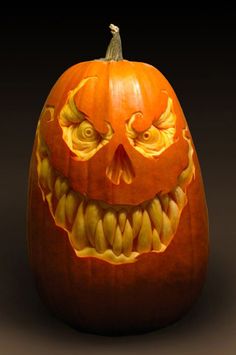 a carved pumpkin with an evil face on it