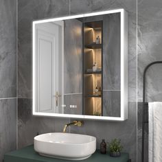 a bathroom sink sitting under a mirror next to a wall mounted faucet with lights on it