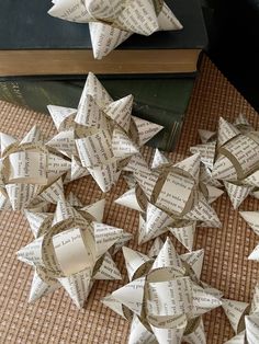 several folded origami stars sitting on top of a table next to a book