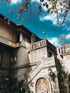 an old castle like building with a clock on it's front and side walls