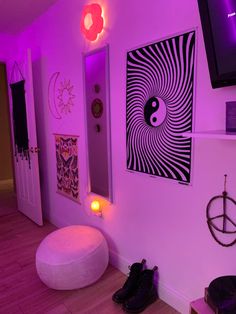 a room with purple lighting and pictures on the wall, including a bean bag ottoman