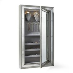 an open mirrored cabinet with jewelry in it on a white background, there is no image here to provide a caption for