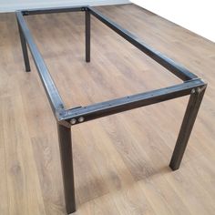 a metal frame sitting on top of a hard wood floor