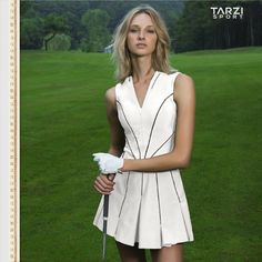 a woman in a white dress holding a golf club