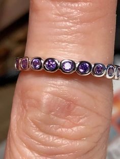 A beautiful natural purple lilac amethyst 925 sterling silver wedding band or stacking band or simply, wear alone. The amethysts are natural and heat treated for color. 925 sterling silver/rhodium Natural purple amethysts Classic Purple Amethyst Ring With Bezel Setting, Classic Amethyst Ring With Bezel Setting, Purple Sterling Silver Birthstone Ring With Round Band, Purple Birthstone Ring With Bezel Setting For Anniversary, Silver Eternity Band With Bezel Setting For Anniversary, White Gold Eternity Band With Bezel Setting As Gift, Fine Jewelry Purple Birthstone Bezel Setting Ring, Fine Jewelry Amethyst Ring With Bezel Setting, Purple Gemstone Stackable Rings In Sterling Silver