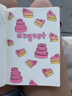 a person holding a notebook with cakes on it and the words august written in pink