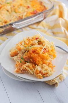 a white plate topped with food next to a casserole dish