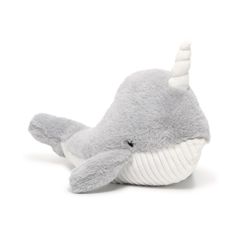 a stuffed narwhale is laying down on the white ground with its mouth open