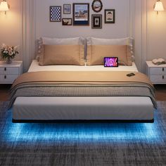 there is a bed that has been lit up with blue lights on the headboard