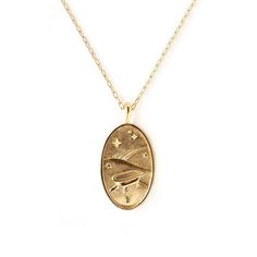 a gold necklace with an image of a bird in flight on the front and bottom