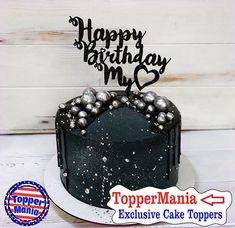 a black and white birthday cake with silver balls on it's topper that says happy birthday mom