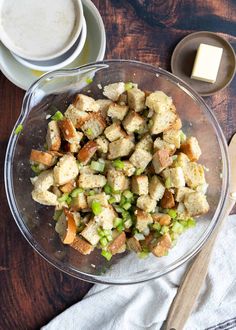 a glass bowl filled with stuffing and peas