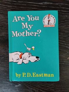 the book are you my mother? by p d eastman on a wooden table